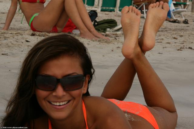 tan girl feet soles pose on the beach